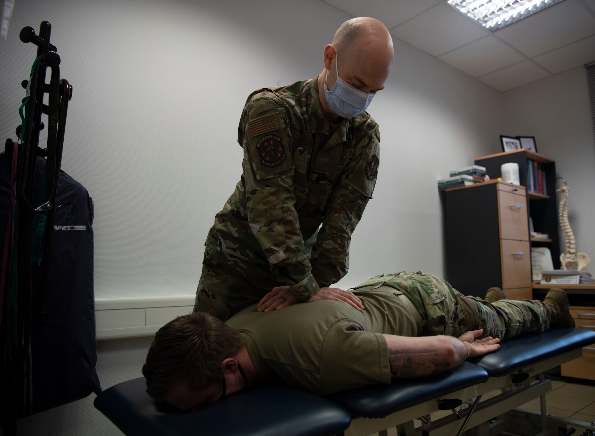 U.S. Air Force 1st Lt. Spencer Carrier, 86th Operational Medical Readiness Squadron physical therapist, performs a chiropractic adjustment on Staff Sgt. Randy Sayer, 86th OMRS physical therapy technician, at Ramstein Air Base, Germany, Jan. 13, 2021.