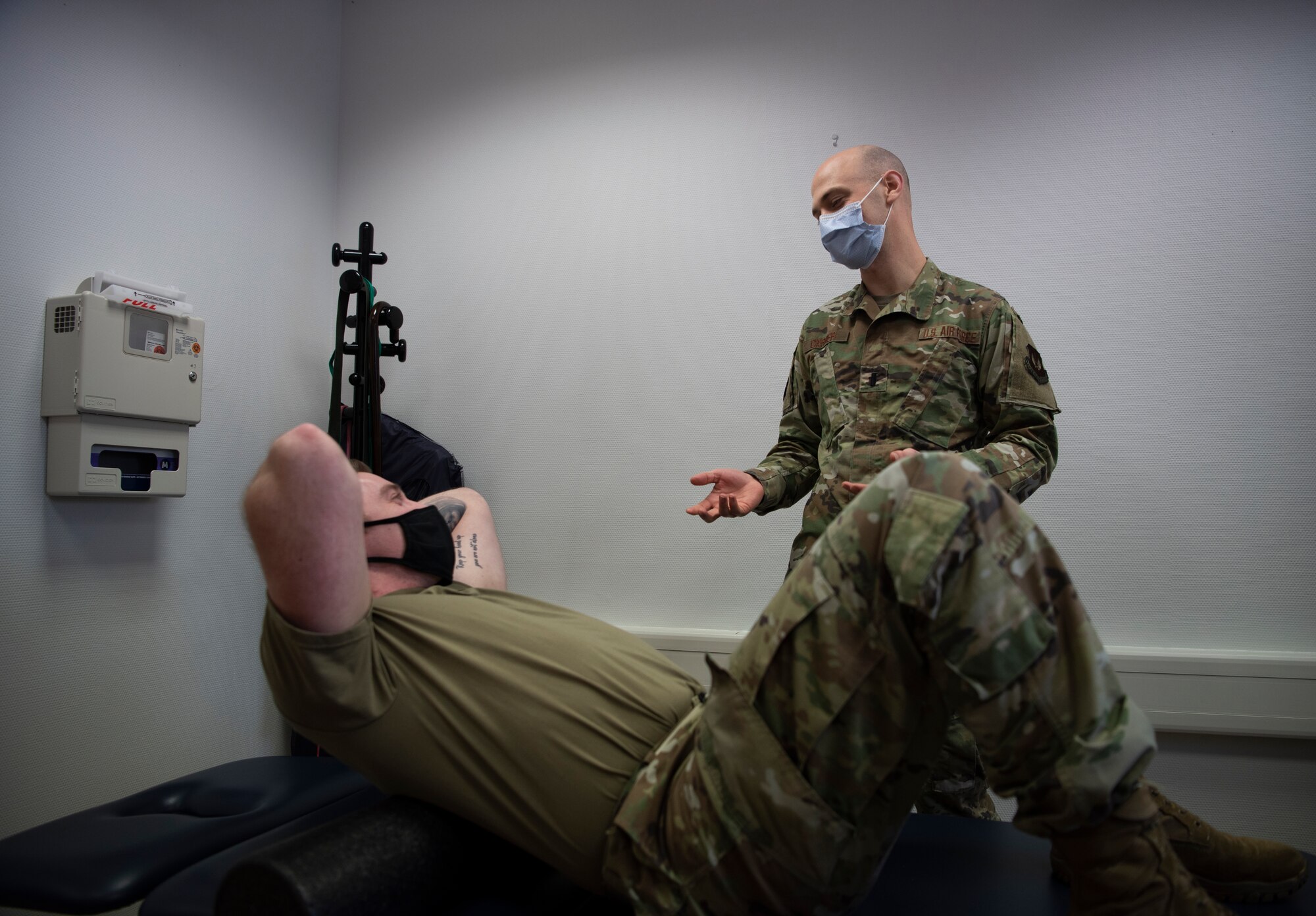 U.S. Air Force 1st Lt. Spencer Carrier, 86th Operational Medical Readiness Squadron physical therapist, explains foam rolling to Staff Sgt. Randy Sayer, 86th OMRS physical therapy technician, at Ramstein Air Base, Germany, Jan. 13, 2021.