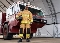 Staff Sgt. Adias Tolliver, 919th Special Operations Civil Engineer Squadron driver operator, poses in front of a fire engine used for training at Duke Field, Florida, Oct. 4, 2020.