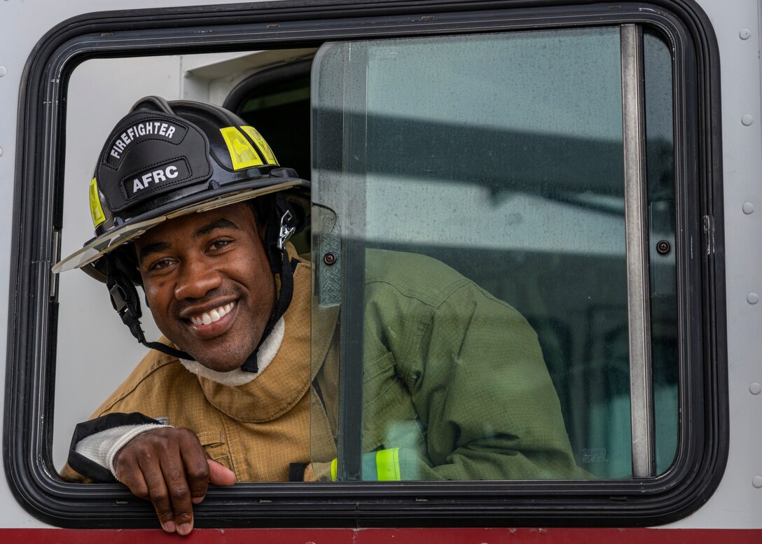 Photo of a firefighter looking out a window