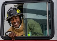 Photo of a firefighter looking out a window