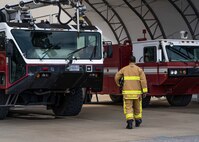 Photo of a firefighter walking near fire engines