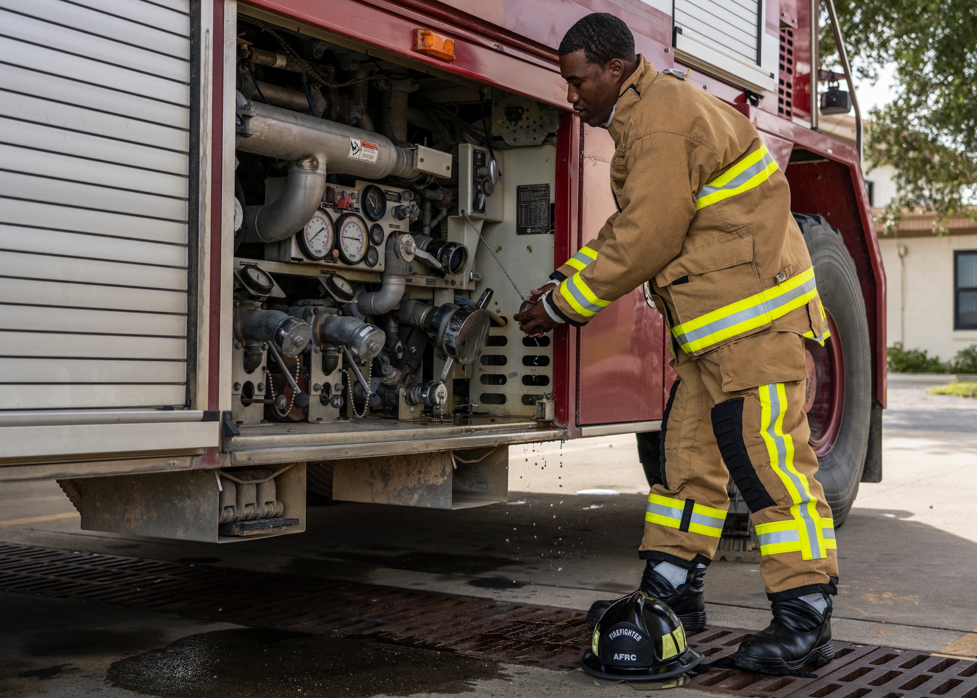 Staff Sgt. Adias Tolliver, 919th Special Operations Civil Engineer Squadron driver operator, demonstrates the use of a water intake valve on a fire engine at Duke Field, Florida, Oct. 4, 2020.