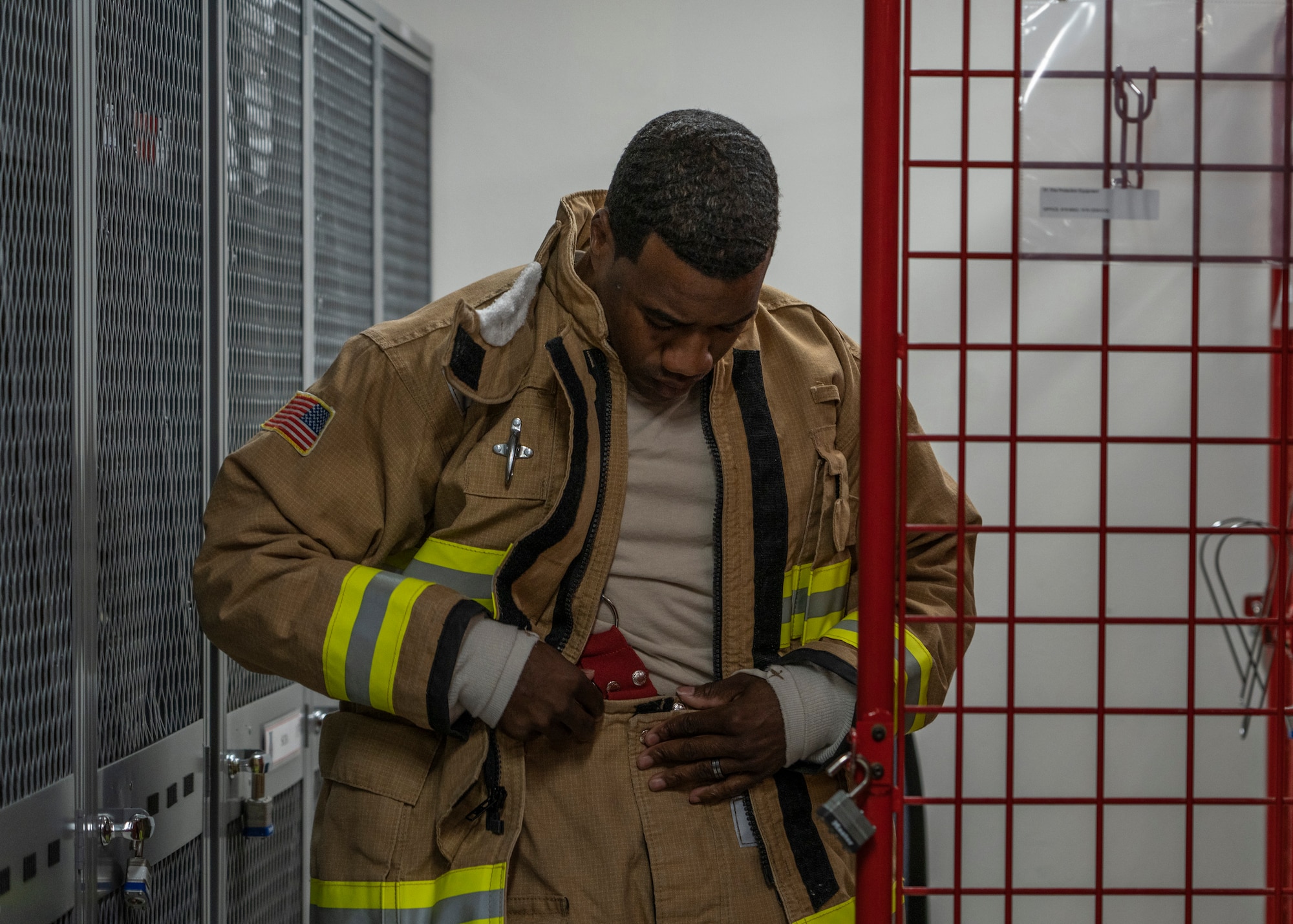 Photo of a firefighter dawning fire clothing