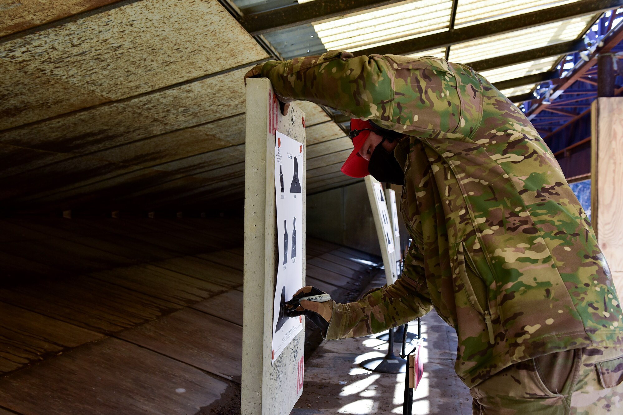 A person reviews a shooting target