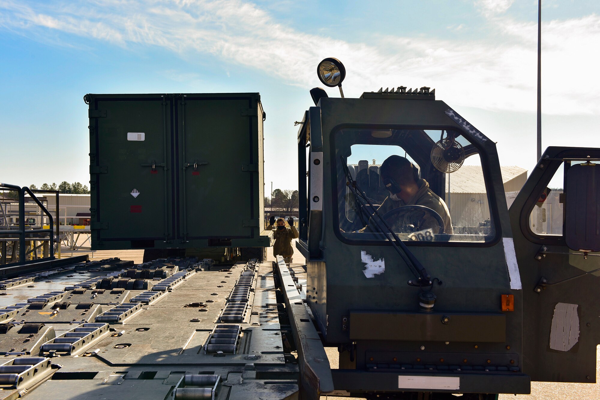 A container of equipment is loaded onto a K-loader