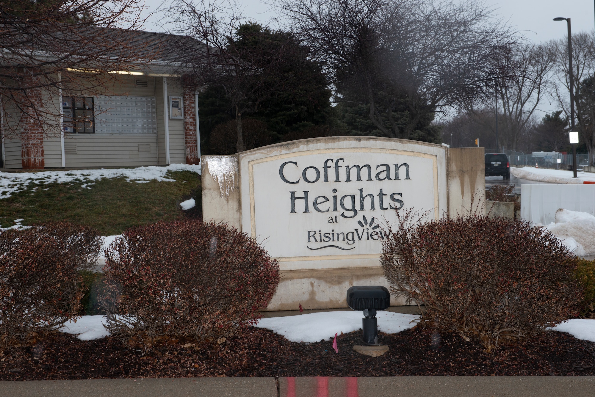 in the forefront of photograph, a large Coffman Heights stone marking the entrance to military housing