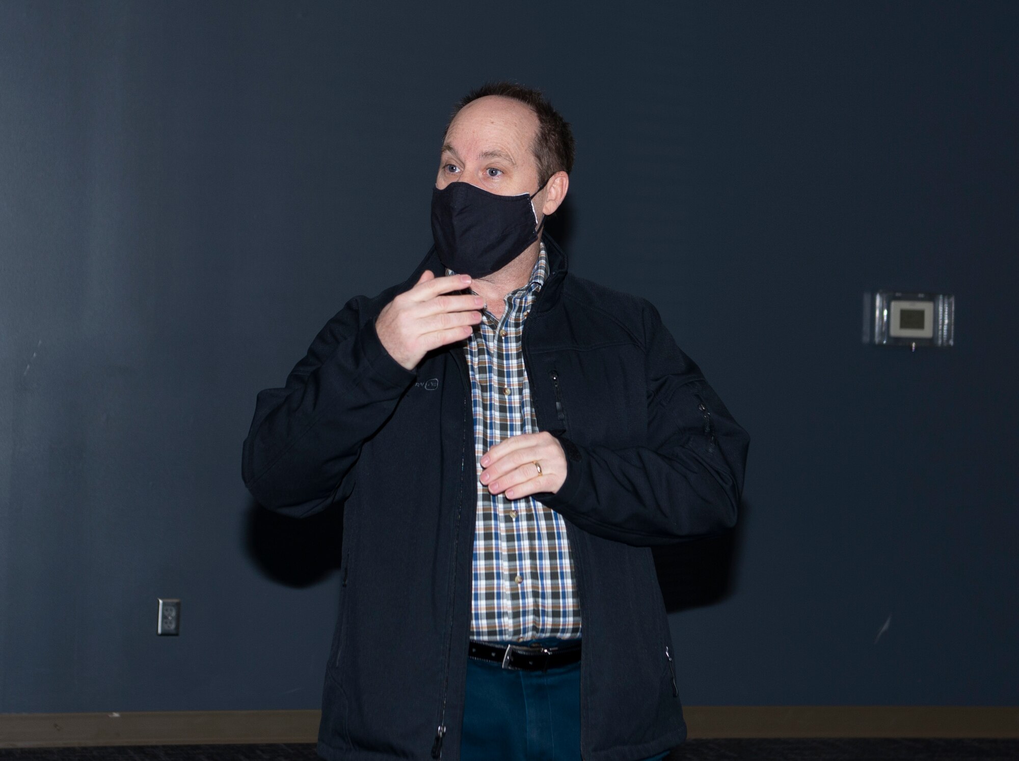 man speaking while wearing face mask