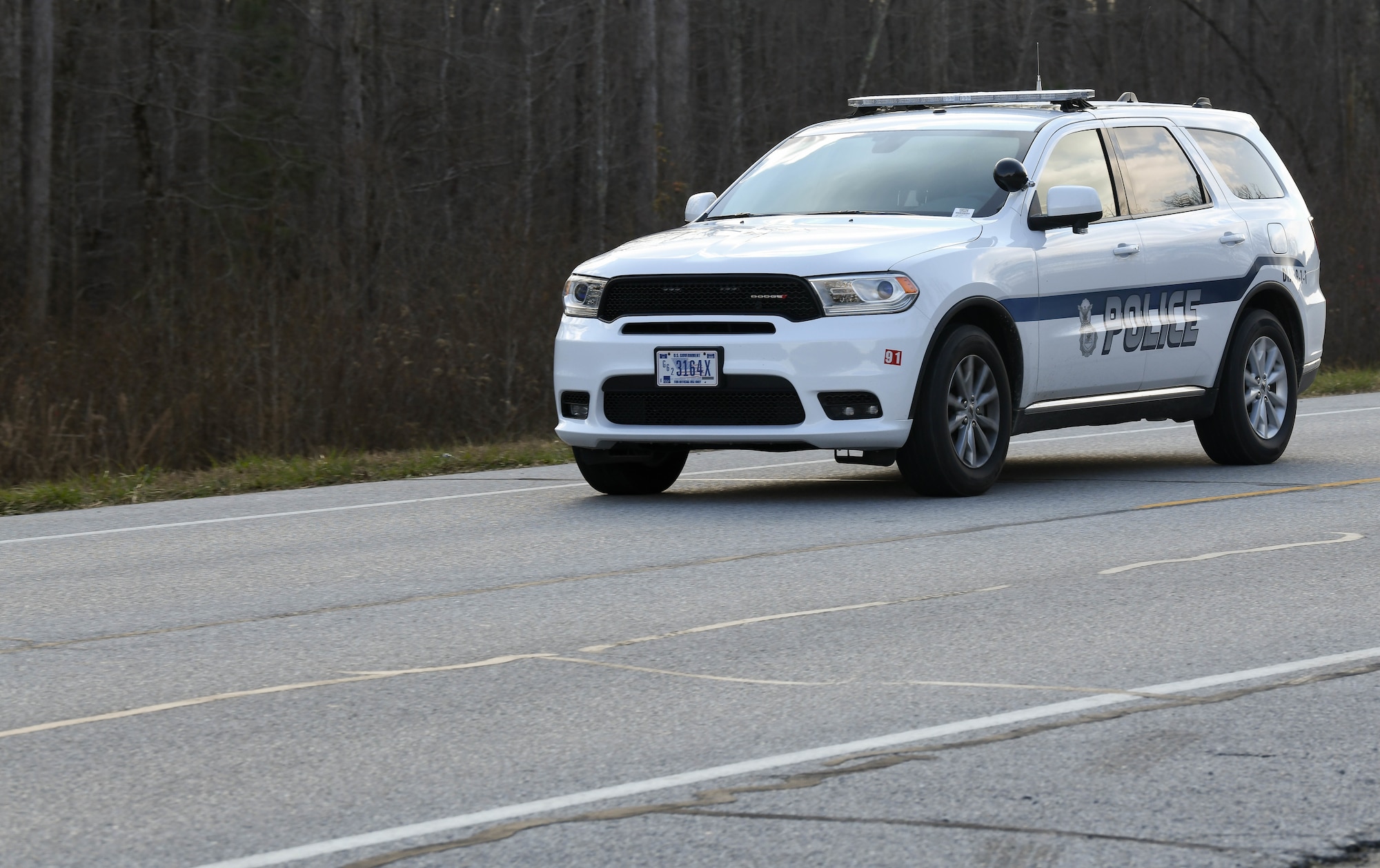 Sgt. George Blasingame, a Dept. of the Air Force Police Officer at Arnold Air Force Base, Tenn, patrols along Wattendorf Highway to watch for motorists committing moving violations, Dec. 17, 2020. DAF Officers began patrolling Arnold in late August. The SUV driven by Blasingame was recently acquired for the new force, and another SUV is also on order. Motorists traveling Arnold AFB roadways should be mindful that the DAF officers can issue citations for moving violations. Motorists who are cited for moving violations on Arnold AFB property are assessed points. Points are entered into the Air Force Justice Information System and assessed against their on-base driving record. Accumulation of 12 points in 12 months or 18 points in 24 months normally results in loss of driving privileges for up to a year. If someone gets caught driving during their revocation period, an additional year is usually added to the penalty. (U.S. Air Force photo by Jill Pickett)