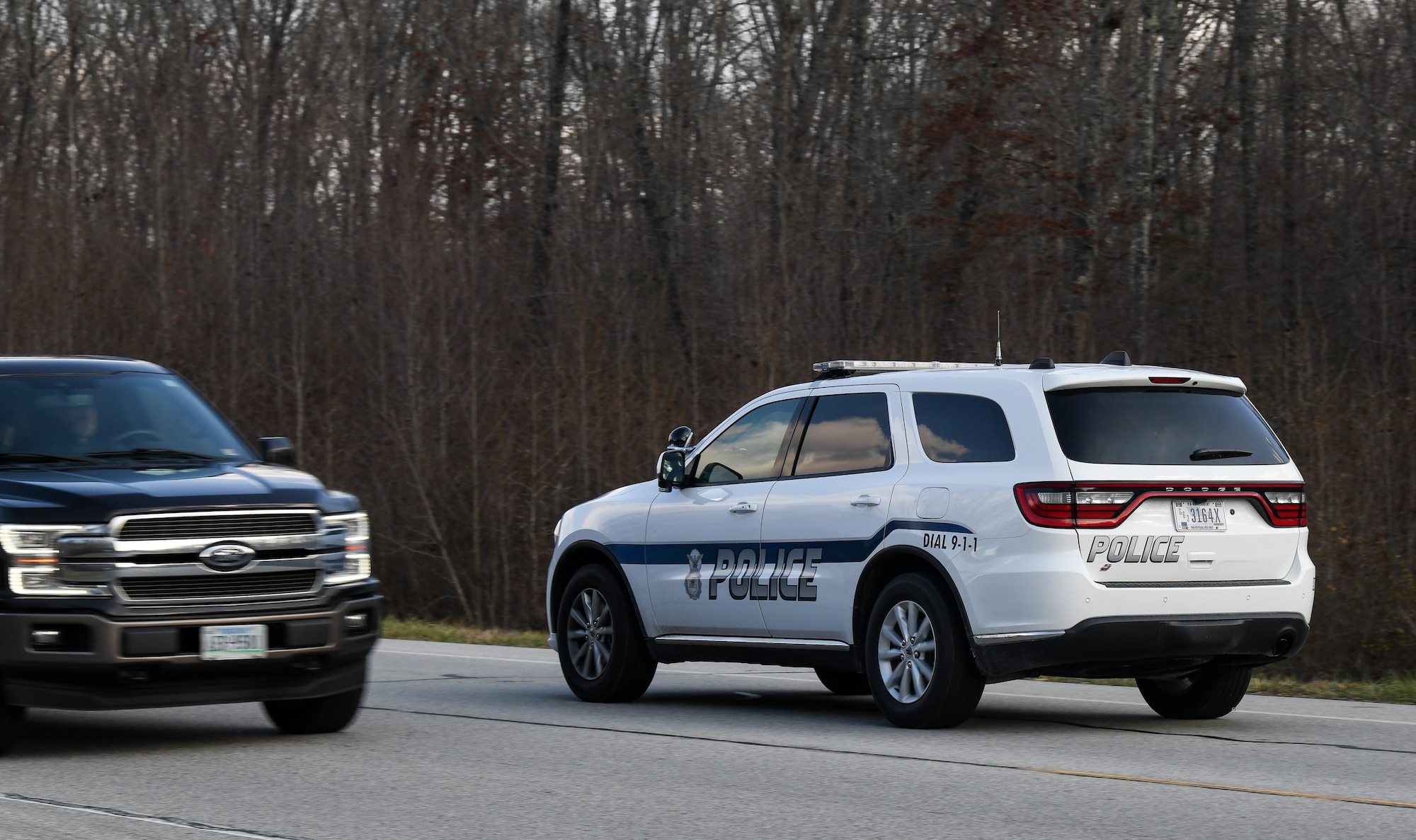 Sgt. George Blasingame, a Dept. of the Air Force Police Officer at Arnold Air Force Base, Tenn, patrols along Wattendorf Highway to watch for motorists committing moving violations, Dec. 17, 2020. DAF Officers began patrolling Arnold in late August. The SUV driven by Blasingame was recently acquired for the new force, and another SUV is also on order. Motorists traveling Arnold AFB roadways should be mindful that the DAF officers can issue citations for moving violations. Motorists who are cited for moving violations on Arnold AFB property are assessed points. Points are entered into the Air Force Justice Information System and assessed against their on-base driving record. Accumulation of 12 points in 12 months or 18 points in 24 months normally results in loss of driving privileges for up to a year. If someone gets caught driving during their revocation period, an additional year is usually added to the penalty. (U.S. Air Force photo by Jill Pickett)