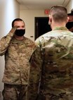 Staff Sgt. Christopher Hotine, 341st Security Forces Squadron military working dog handler, salutes Maj. Derek Tosie, 341st SFS commander, Jan. 14, 2021 at the Chapel on Malmstrom AFB, Mont.