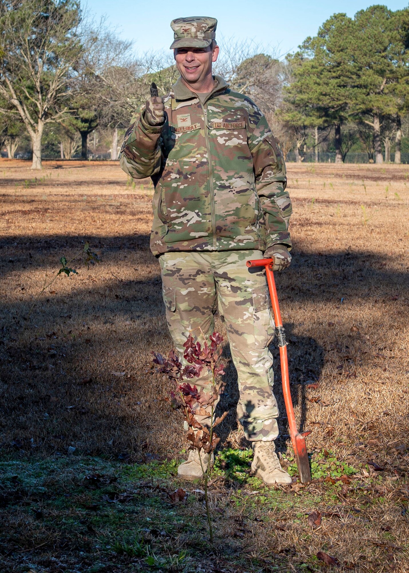 Col. Anthony Mullinax, 4th Mission Support Group commander, gives a thumbs up after planting a tree at Seymour Johnson Air Force Base, North Carolina, Jan. 13, 2021.