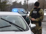 Pvt. Jonas Schroeder conducts a traffic stop on the Camp Ethan Allen Training Site in Jericho, Vermont, during a task evaluation Jan. 16, 2021. Schroeder and other Soldiers with the 172nd Law Enforcement Detachment are training on law enforcement duties in preparation for a deployment in support of U.S. Army Europe and Africa. (U.S. Army National Guard photo by Don Branum)