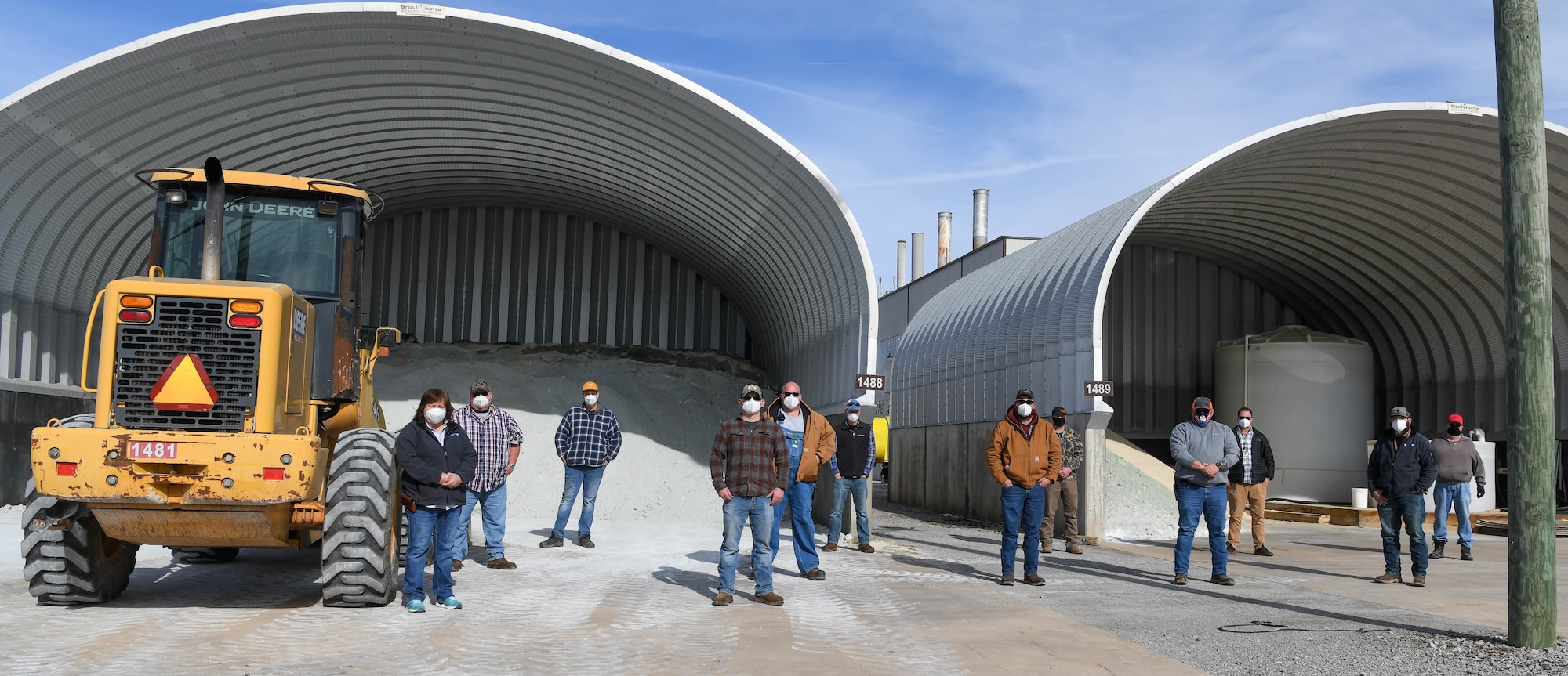 Arnold Engineering Development Complex Heavy Equipment crew members with Base Operations and Support at Arnold Air Force Base, Tenn., pause from their workday for a socially-distanced photo in front of the salt sheds, Jan. 6, 2021. The crew responds when winter weather threatens the area and increases the risk of hazardous travel. (U.S. Air Force photo by Jill Pickett)