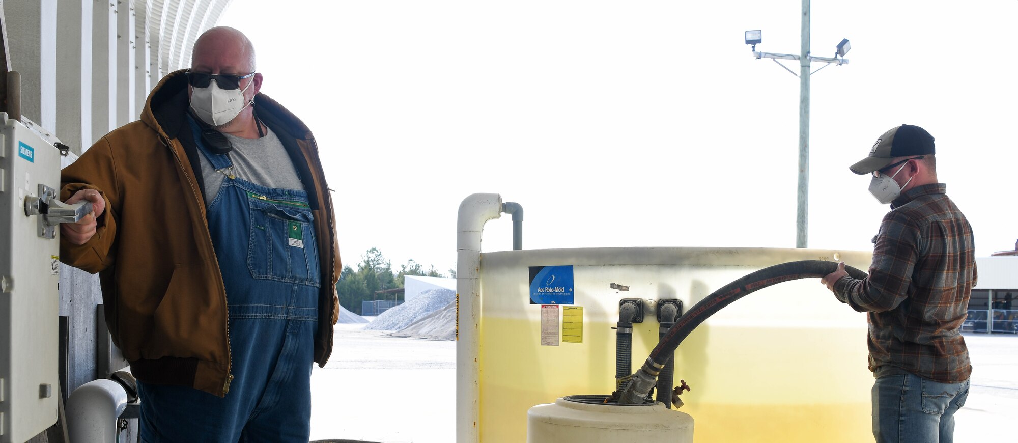 Arnold Engineering Development Complex Heavy Equipment crew members Tony Buchanan, left, and Blake Braden, both laborers, prepare for possible winter weather by making a brine solution to be used on roadways, Jan. 6, 2021, at Arnold Air Force Base, Tenn. (U.S. Air Force photo by Jill Pickett)