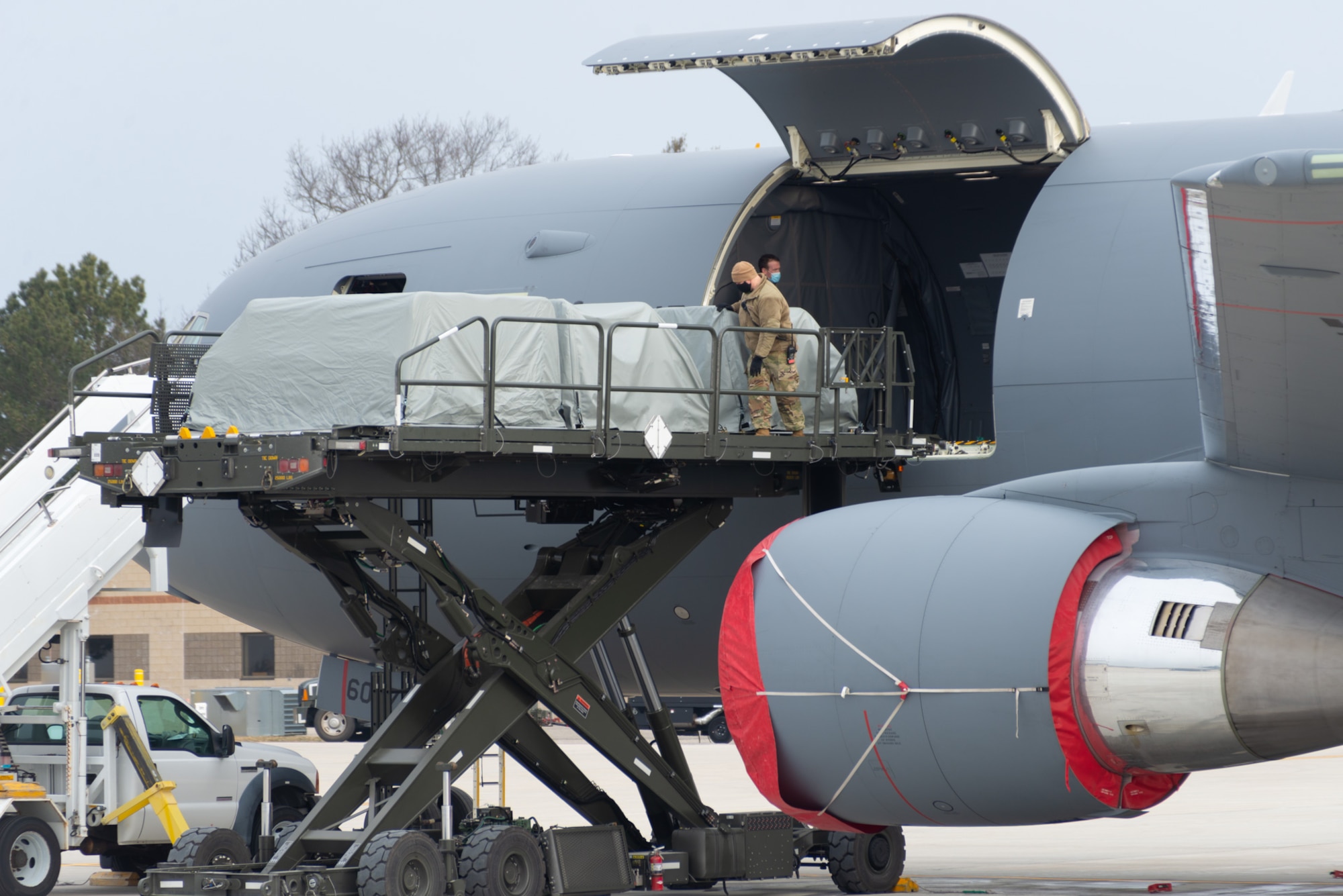U.S. Air Force Master Sgt. Timothy Dupuis and Tech. Sgt. Sean Avery, both assigned to the 157th Maintenance Group, New Hampshire Air National Guard, load seat pallets onto a KC-46A tanker at Pease Air National Guard Base, New Hampshire, Jan. 14, 2021. The tanker is one of Pease’s three jets being used to transport about 500 National Guardsmen from New Hampshire, Oklahoma and Nevada to Washington D.C. to provide security during Inauguration Day Jan. 20. (U.S. Air Force photo by Tech. Sgt. Aaron Vezeau)