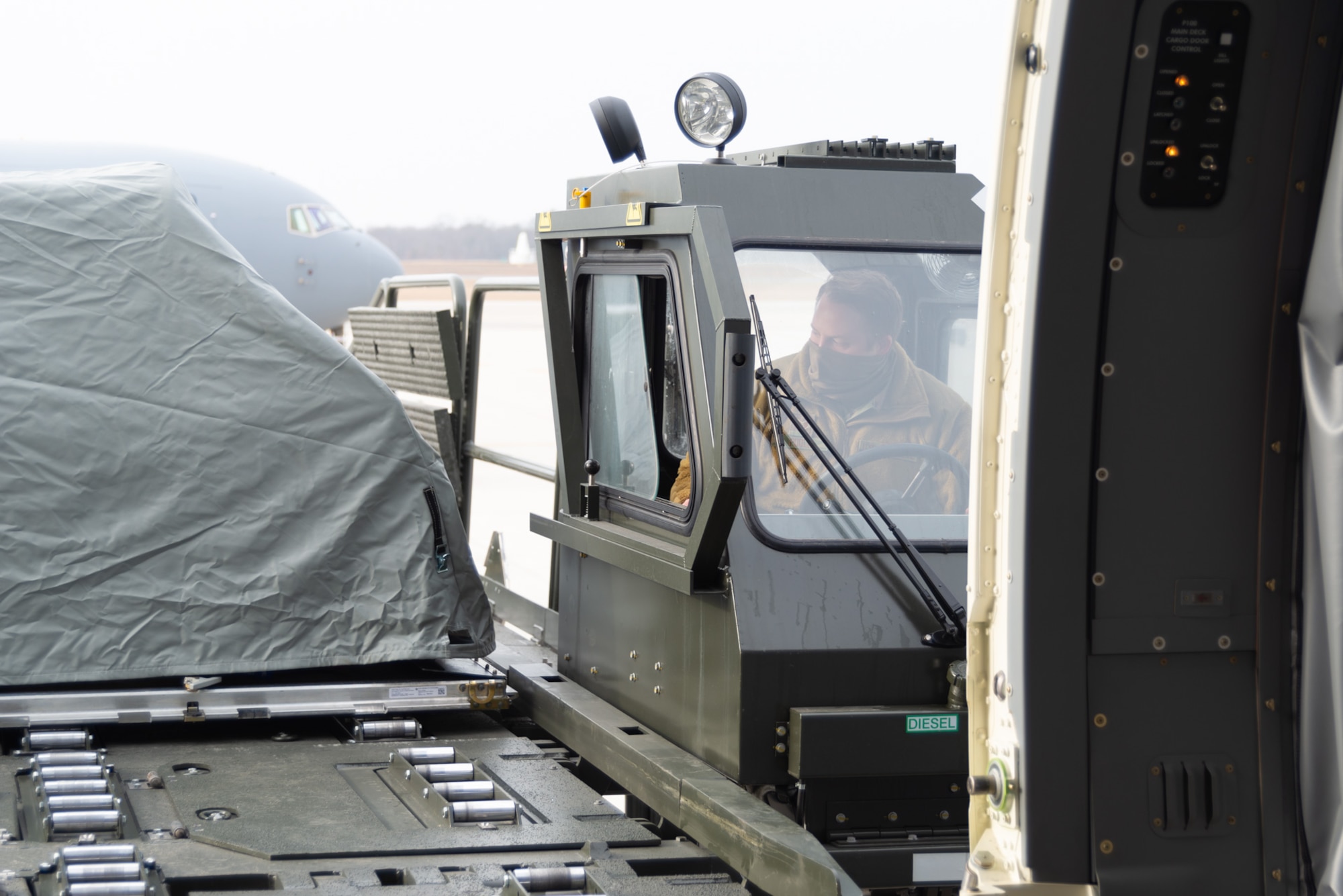 U.S. Air Force Staff Sgt. Andrew Poole, assigned to the 157th Maintenance Group, New Hampshire Air National Guard, operates a Halvorsen pallet loader to load seat pallets onto a KC-46A at Pease Air National Guard Base, New Hampshire. The tanker is one of Pease’s three jets being used to transport about 500 National Guardsmen from New Hampshire, Oklahoma and Nevada to Washington D.C. to provide security during Inauguration Day Jan. 20. (U.S. Air Force photo by Tech. Sgt. Aaron Vezeau)