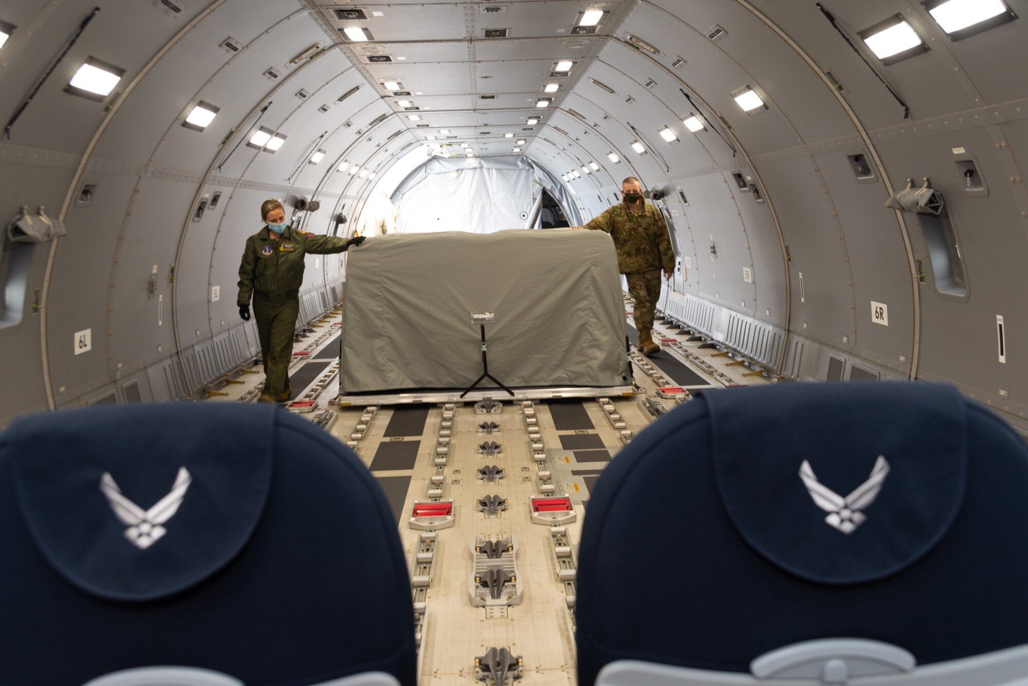 U.S. Air Force Tech. Sgt. Natalie Belongie and Staff Sgt. Christopher Ager, both assigned to the 157th Air Refueling Wing, New Hampshire Air National Guard, load seat pallets in a KC-46A, Pease Air National Guard Base, New Hampshire, Jan. 14, 2021. The tanker is one of Pease’s three jets being used to transport about 500 National Guardsmen from New Hampshire, Oklahoma and Nevada to Washington D.C. to provide security during Inauguration Day Jan. 20. (U.S. Air Force photo by Tech. Sgt. Aaron Vezeau)