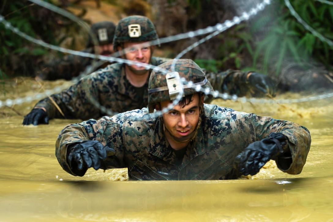 Marines navigate a water obstacle.