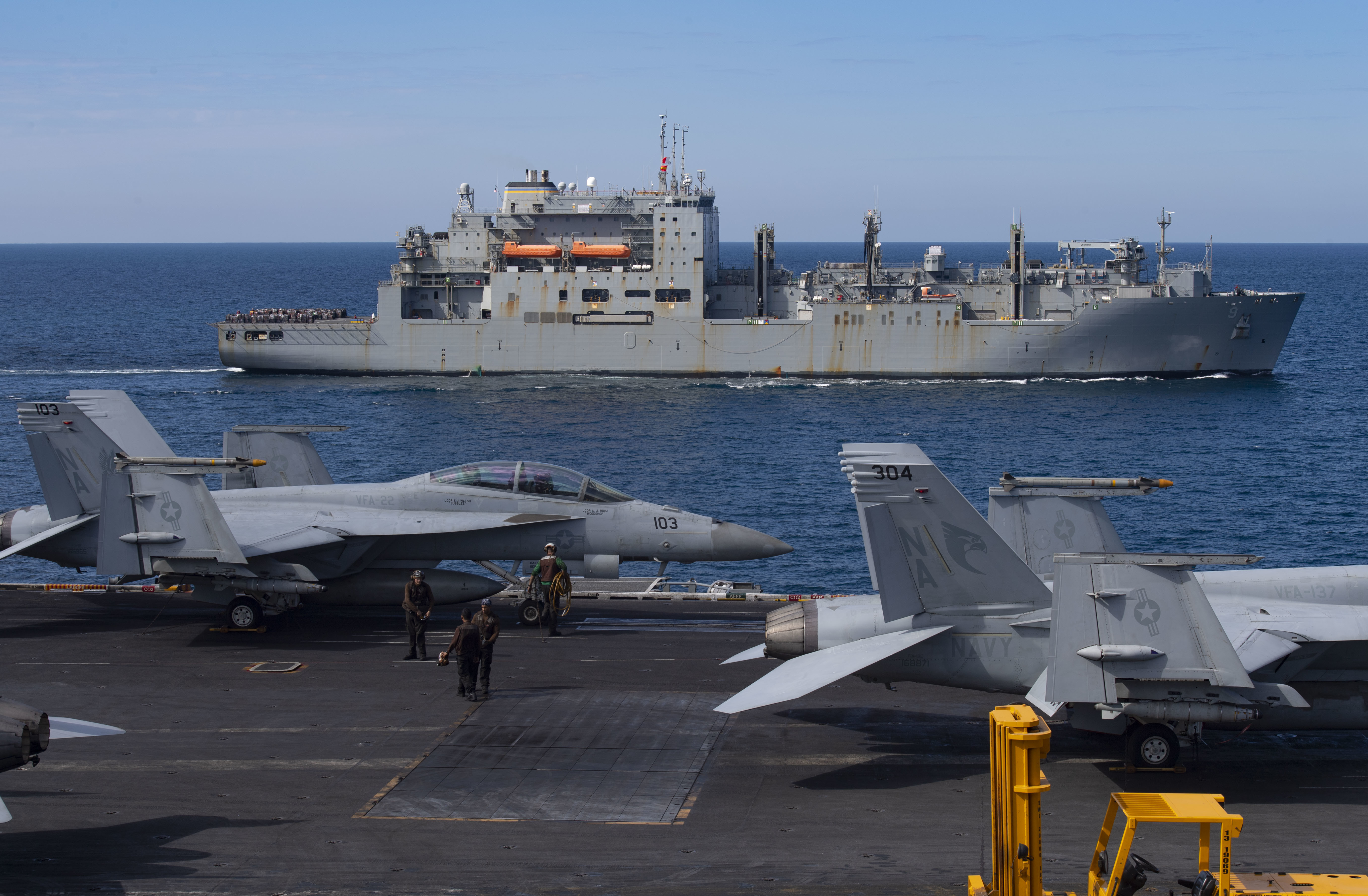 The Lewis and Clark-class dry cargo ship USNS Matthew Perry (T-AKE-9) steams alongside the aircraft carrier USS Nimitz (CVN 68) during a replenishment-at-sea evolution.
