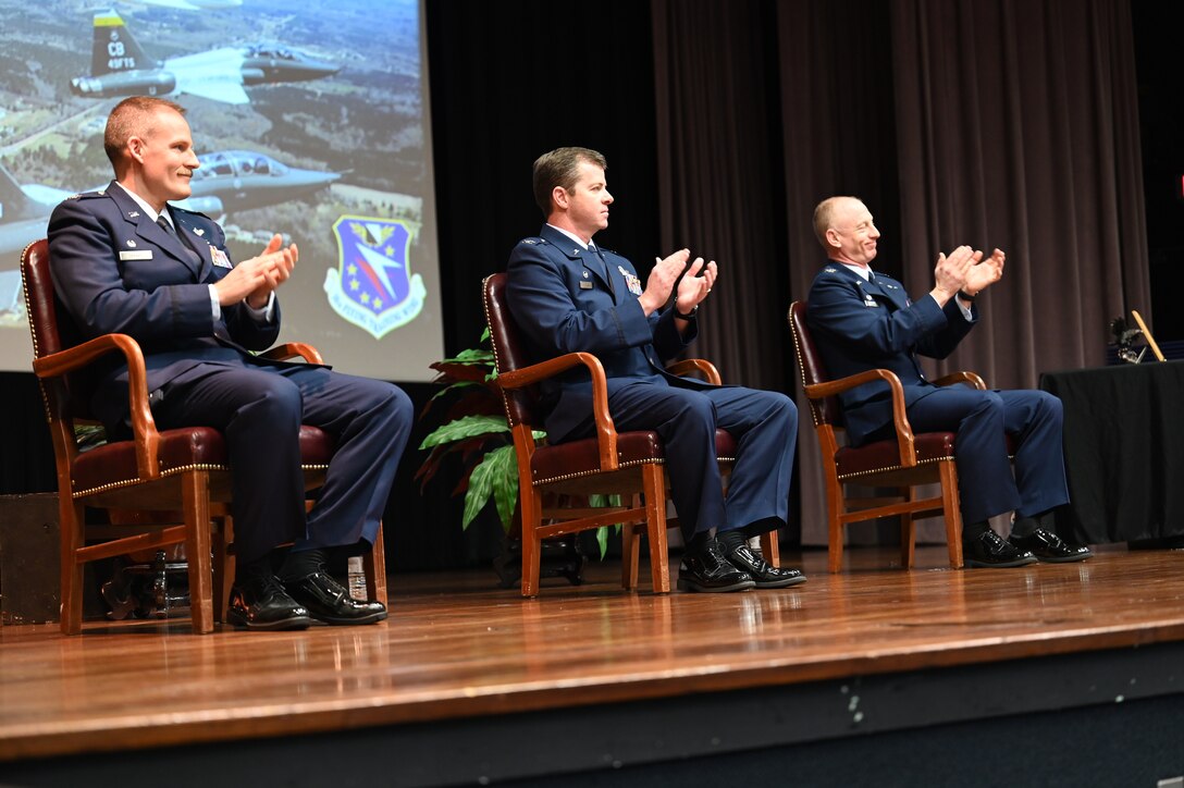 U.S. Air Force Col. Justin Spears, 14th Flying Training Wing Operations Group commander (Left), Col. James Akers, 1st Operations Group commander at Joint Base Langley-Eustis, Virginia, and Col. Seth Graham, 14th Flying Training Wing commander (Right), congratulate the Air Force’s newest pilots during a graduation ceremony, Jan. 15, 2020, on Columbus Air Force Base, Miss. (U.S. Air Force photo by Airman 1st Class Jessica Haynie)