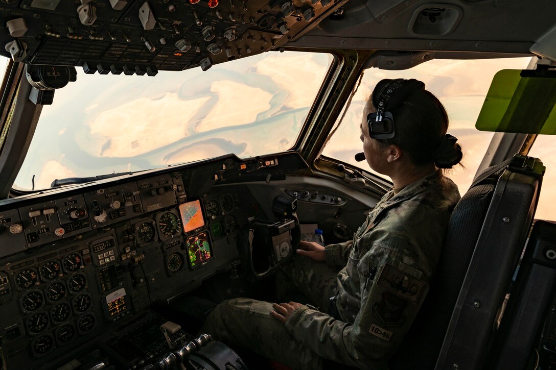 A pilot sits in a cockpit.