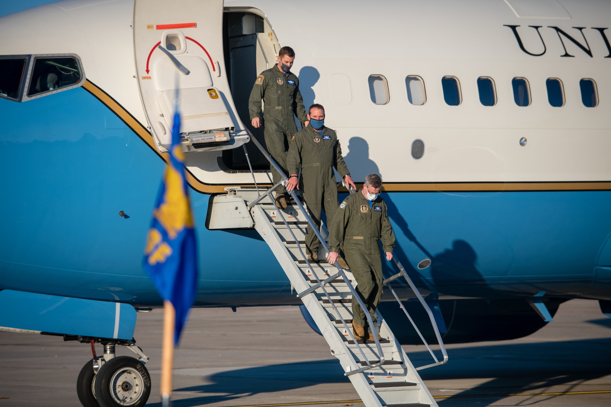 Led by 932nd Operations Group commander, Col. Mike Maloney, Lt. Col. Ryan Geilhausen, outgoing OSF commander and Lt. Col. Alan Rathjen, incoming commander, exit a C-40C as part of the 932nd Operations Support Flight change of command ceremony, December 4, 2020, Scott Air Force Base, Illinois. (U.S. Air Force photo by Christopher Parr)