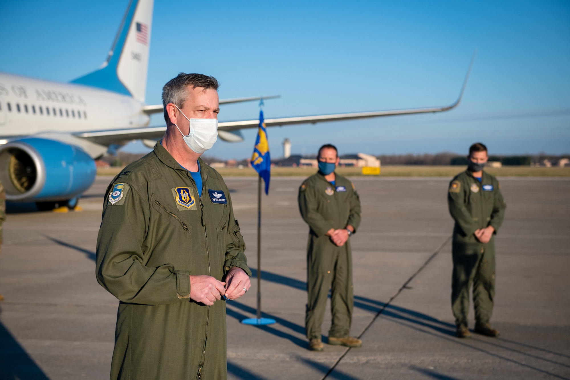 Col. Mike Maloney, 932nd Operation Group commander, shares some remarks  as Lt. Col. Ryan Geilhausen, outgoing OSF commander and Lt. Col. Alan Rathjen, incoming commander, both look on, during the 932nd Operations Support Flight change of command ceremony, December 4, 2020, Scott Air Force Base, Illinois. (U.S. Air Force photo by Christopher Parr)