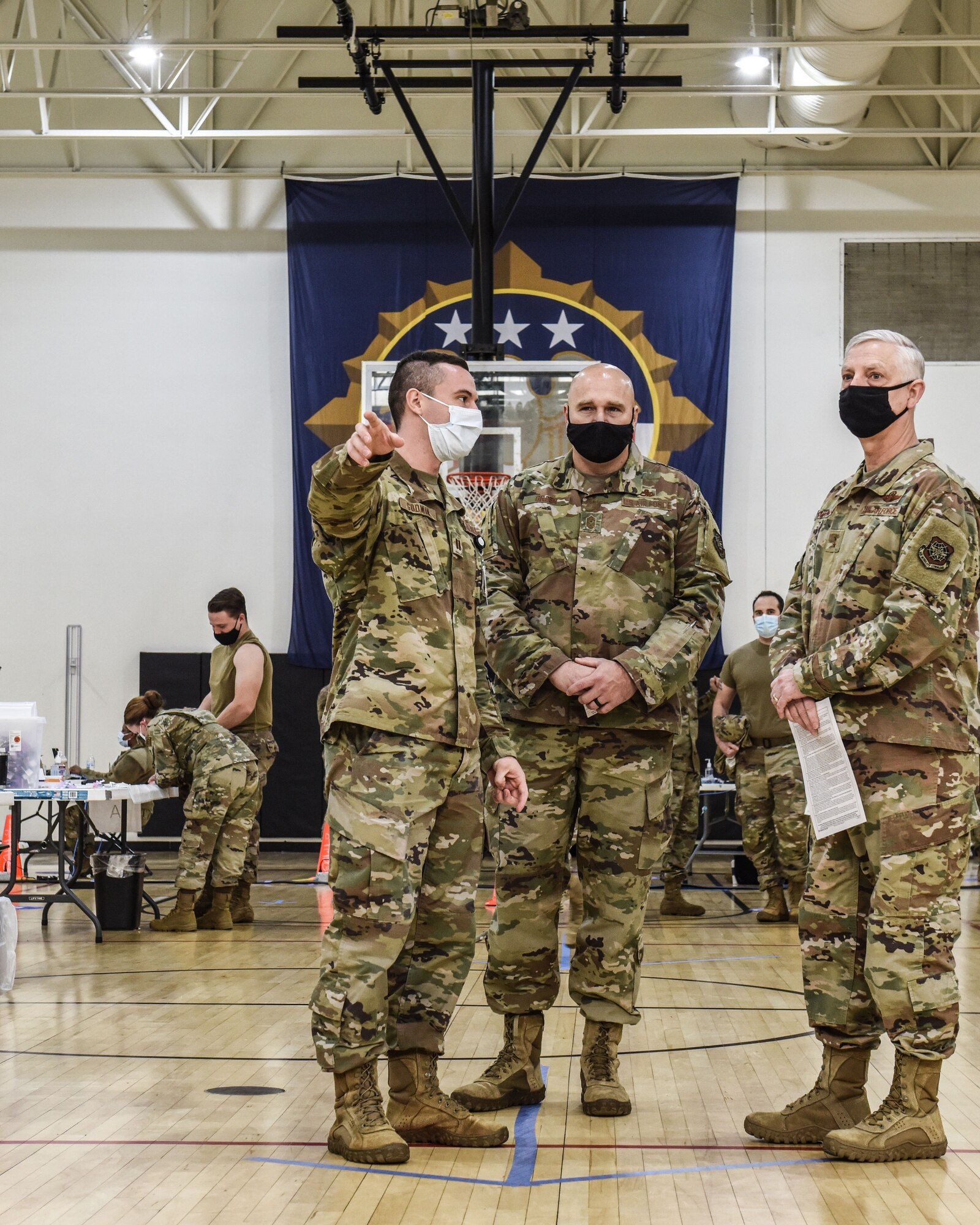 Three Airmen share a conversation.