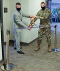 James Driscoll, 50th Force Support Squadron Development Flight chief, left, and Col. James Smith, Peterson-Schriever Garrison commander, prepare to cut a ribbon to commemorate the re-opening of the Force Development Center inside of Bldg. 210 at Schriever Air Force Base, Colorado, Jan. 12, 2021. Upgrades include sound-proof walls beneficial for testing and new spaces for staff and the center to hold the College Level Examination Program and the Dantes Subject Standardized Test. 
(U.S. Space Force photo by Marcus Hill)