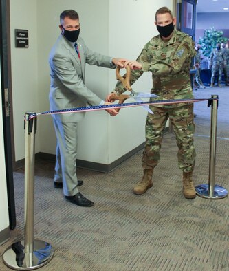 James Driscoll, 50th Force Support Squadron Development Flight chief, left, and Col. James Smith, Peterson-Schriever Garrison commander, prepare to cut a ribbon to commemorate the re-opening of the Force Development Center inside of Bldg. 210 at Schriever Air Force Base, Colorado, Jan. 12, 2021. Upgrades include sound-proof walls beneficial for testing and new spaces for staff and the center to hold the College Level Examination Program and the Dantes Subject Standardized Test. 
(U.S. Space Force photo by Marcus Hill)
