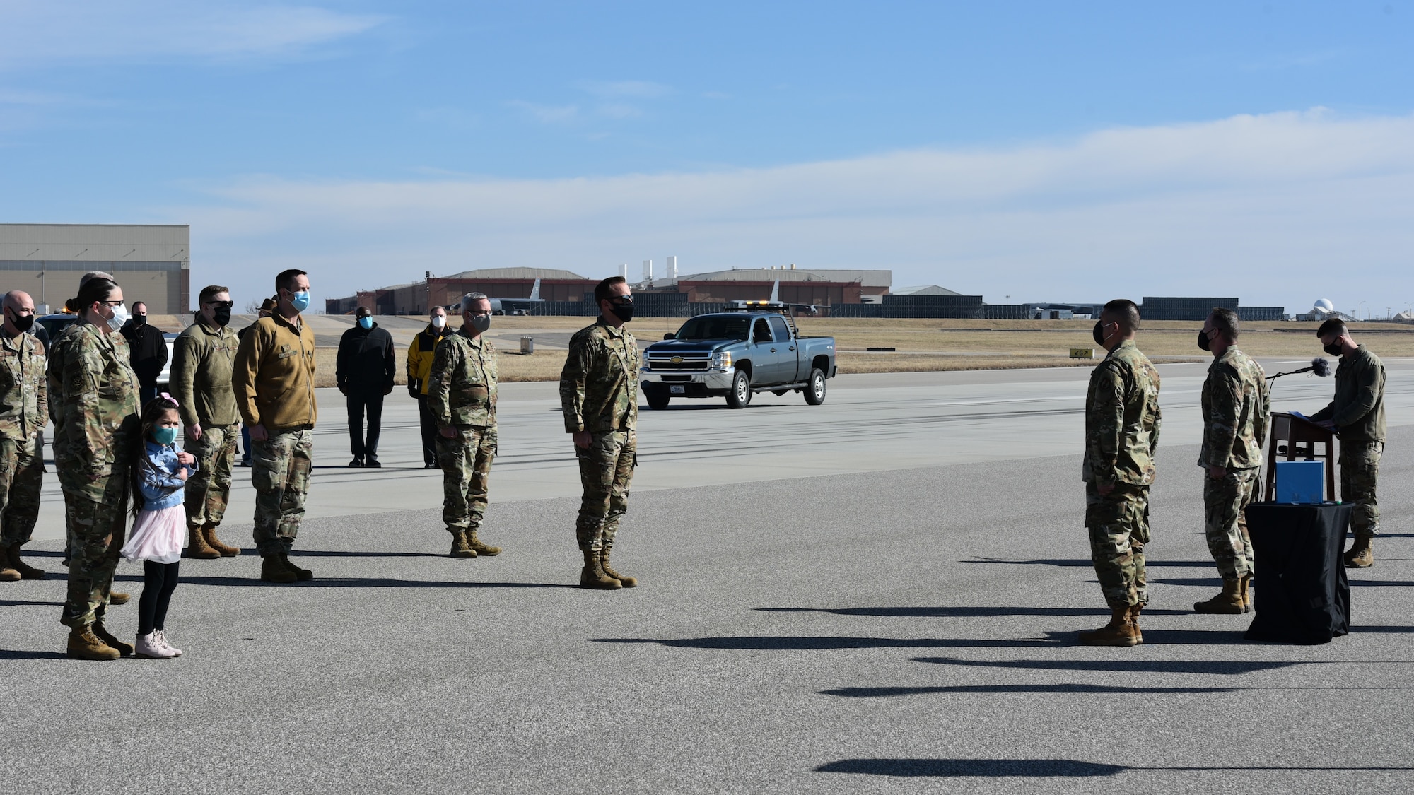 Airmen standing on runway during award presentation ceremony