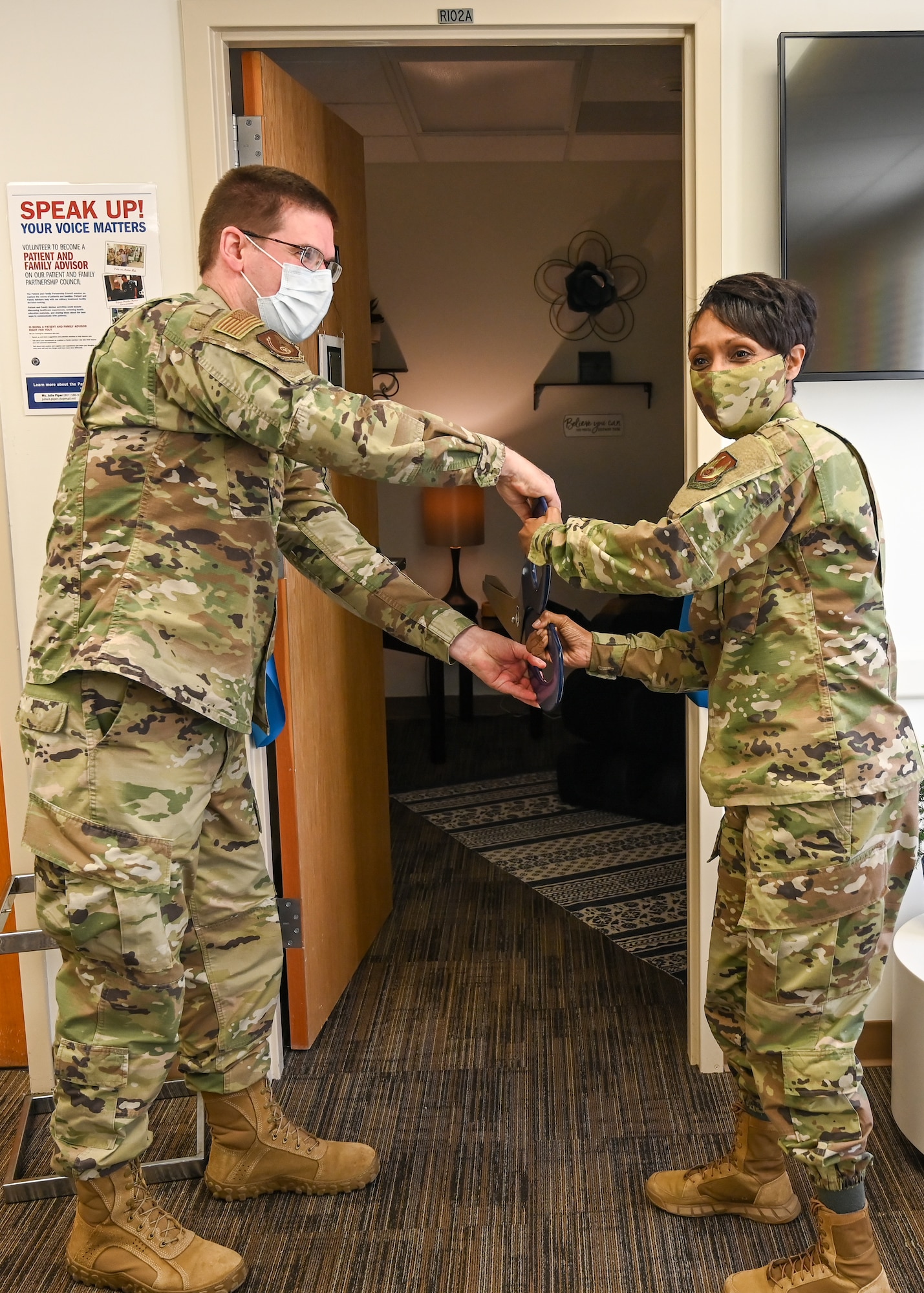 Col. Jenise Carroll cuts the ribbon during a ribbon-cutting ceremony for the opening of the comfort room.