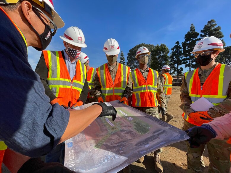 Ivan Caceres, left, quality assurance and construction control representative with the U.S. Army Corps of Engineers Los Angeles District, describes the layout of the new Community Living Center to Lt. Gen. Scott A. Spellmon, center, U.S. Army Corps of Engineers commanding general and chief of engineers, during his visit Jan. 13, 2021, to the construction site at the Veterans Affairs Long Beach Healthcare System complex in Long Beach, California.