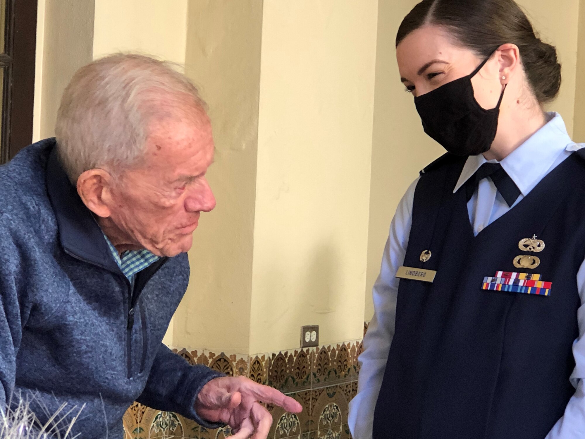 U.S. Air Force Maj. Jennifer Lindberg, 6th Aircraft Maintenance Squadron commander, meets with World War II veteran Henry Sayler during his 100th birthday celebration at North Shore Park, St. Petersburg, Florida Jan. 16, 2021. Lindberg, a direct descendant of the famed aviator Charles Lindbergh, along with other MacDill service members, presented a letter of appreciation from Col. Benjamin Jonsson, 6th Air Refueling Wing commander, honoring Sayler’s service to our nation and his centennial birthday. (Courtesy photo)