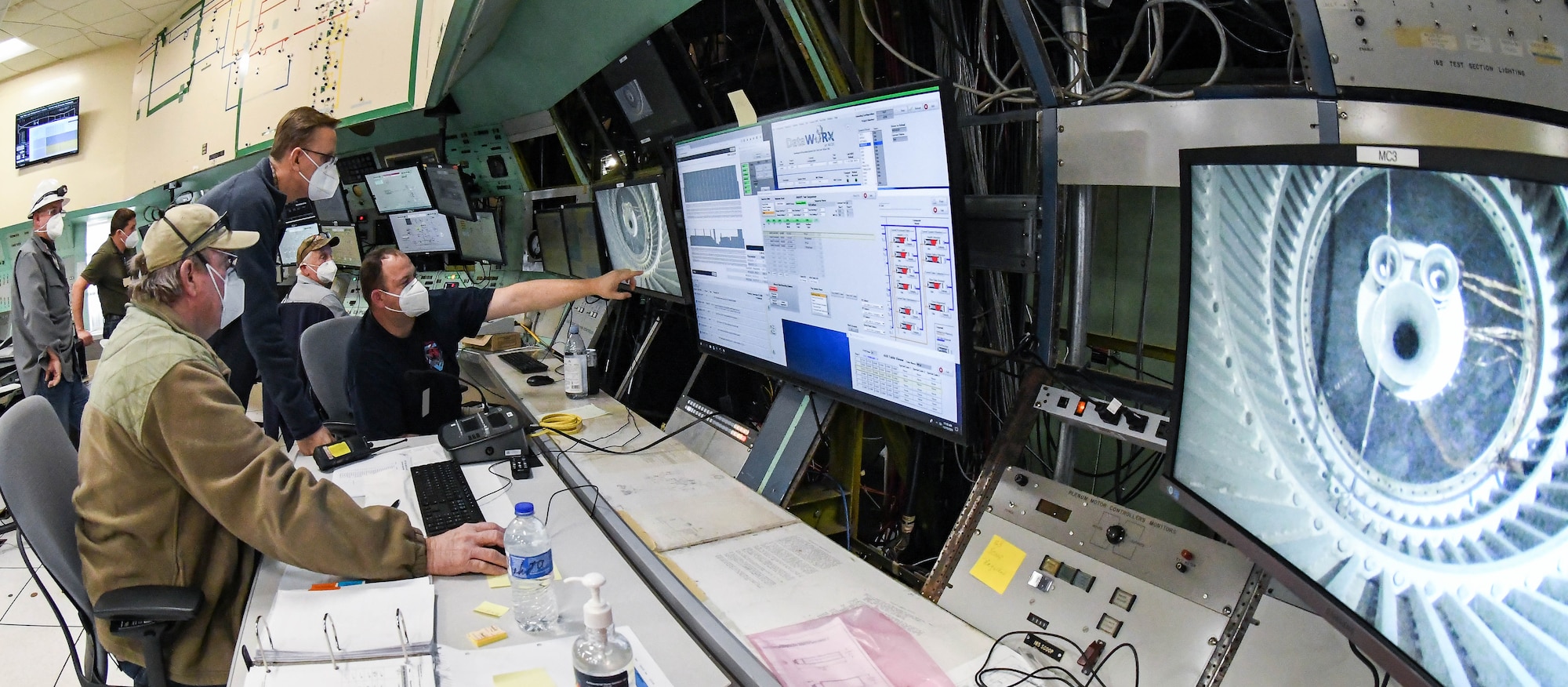 Ray Steuer, right, an instrument technician, speaks with Greg Sandlin, a test operations engineer, center, and Robert McKendrick, an instrument technician, about the placement of sensors for the calibration of a mass flow assembly in the Arnold Engineering Development Complex 16-foot supersonic wind tunnel, Nov. 19, 2020, at Arnold Air Force Base, Tenn. (U.S. Air Force photo by Jill Pickett) (This image has been altered by obscuring badges for security purposes.)