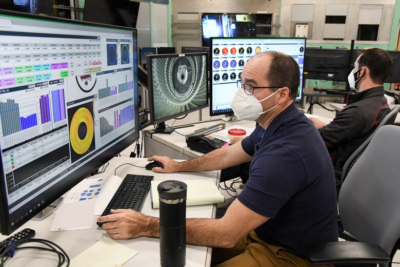 Nathan Payne, left, propulsion subject matter expert for the Aerodynamics Test Branch, Test Division, Arnold Engineering Development Complex, watches data as it is collected during a test run in the 16-foot supersonic wind tunnel to calibrate a mass flow assembly, Nov. 19, 2020, at Arnold Air Force Base, Tenn. Calibration of large-scale MFAs is a new capability in 16S. (U.S. Air Force photo by Jill Pickett) (This image has been altered by obscuring an item for security purposes.)
