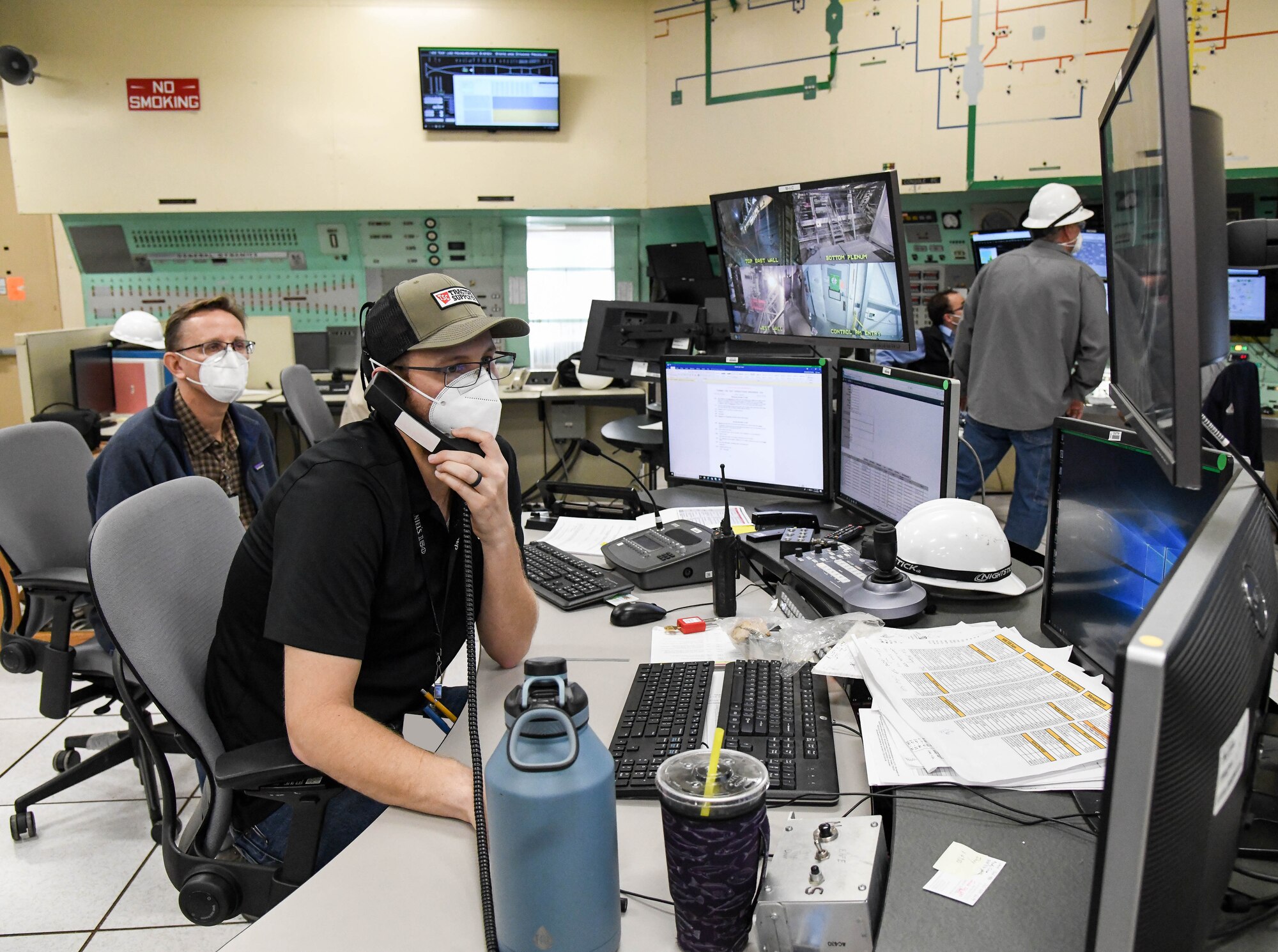 Ben Howell, a test operations engineer, coordinates a run in the 16-foot supersonic wind tunnel to prepare for operations to calibrate a mass flow assembly, Nov. 19, 2020, at Arnold Air Force Base, Tenn. Also pictured is Greg Sandlin, a test operations engineer. (U.S. Air Force photo by Jill Pickett) (This image has been altered by obscuring badges for security purposes.)