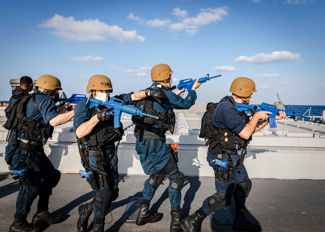 Sailors simulate conducting compliant boarding on the aft missile deck en route to the pilot house during a visit, board, search and seizure (VBSS) drill aboard the Arleigh Burke-class guided-missile destroyer USS John S. McCain (DDG 56).