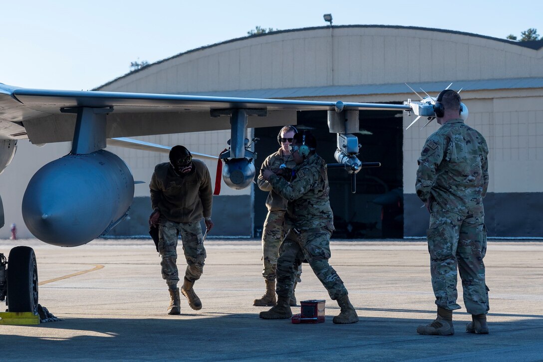 Photo of Airmen working on an F-16.