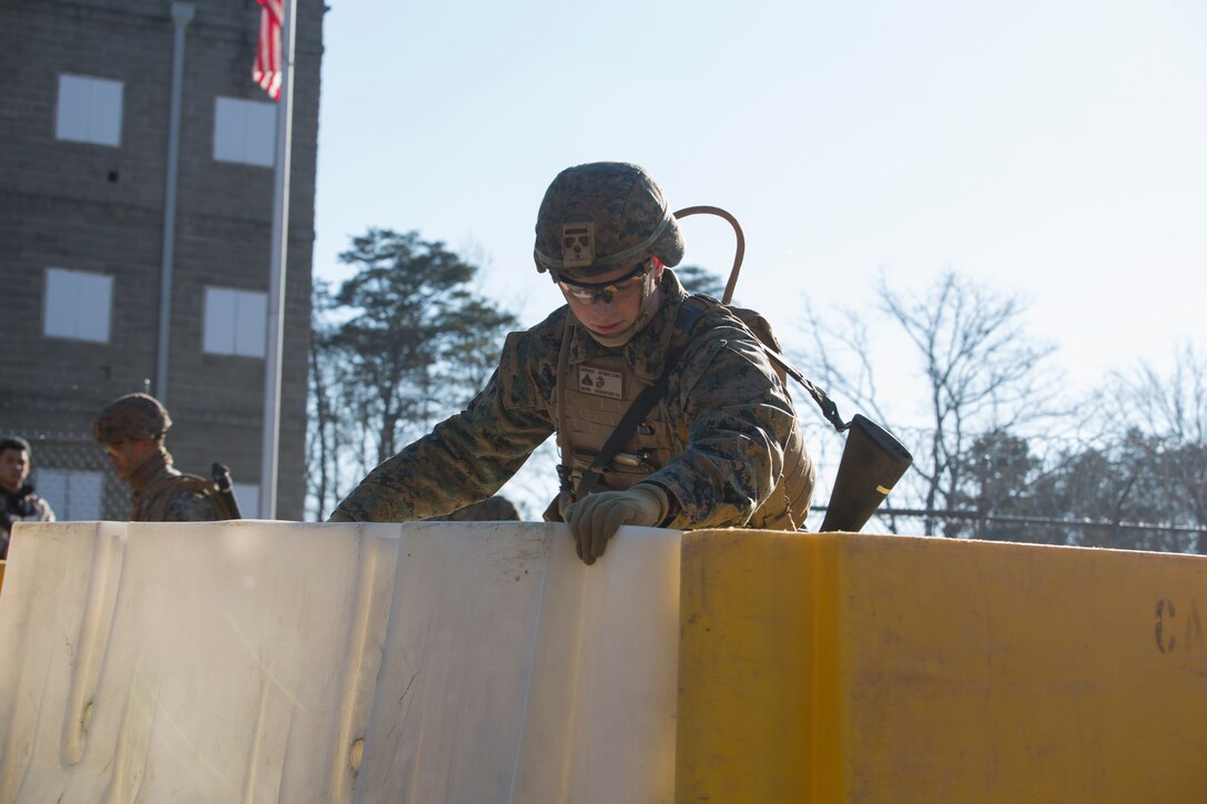 U.S. Marine Corps Cpl. William Dardeen, a designated marksman with Charlie FAST Company, 5th Platoon, Marine Corps Security Forces, U.S. Marine Corps Forces Command, Fleet Marine Force Atlantic, sets up defensive barriers during a Mission Readiness Exercise (MRX) Jan 12, 2021, on Fort A. P. Hill in Port Royal, Virginia. Fleet Antiterrorism Security Team (FAST) platoons execute MRX exercises prior to deployment to evaluate the platoons’ proficiency in core mission essential tasks. (U.S. Marine Corps Photo by Sgt. Desmond Martin/Released)