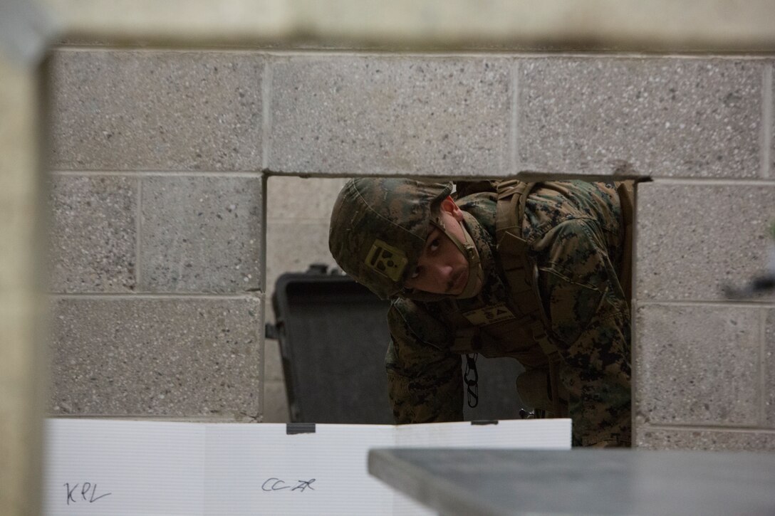 U.S. Marine Corps Lance Cpl. Miguel Luster, a military police officer with Charlie FAST Company, 5th Platoon, Marine Corps Security Forces, U.S. Marine Corps Forces Command, Fleet Marine Force Atlantic, sets up equipment in the command and control room during a Mission Readiness Exercise (MRX) Jan 12, 2021, on Fort A. P. Hill in Port Royal, Virginia. Fleet Antiterrorism Security Team (FAST) platoons execute MRX exercises prior to deployment to evaluate the platoons’ proficiency in core mission essential tasks. (U.S. Marine Corps Photo by Sgt. Desmond Martin/Released)