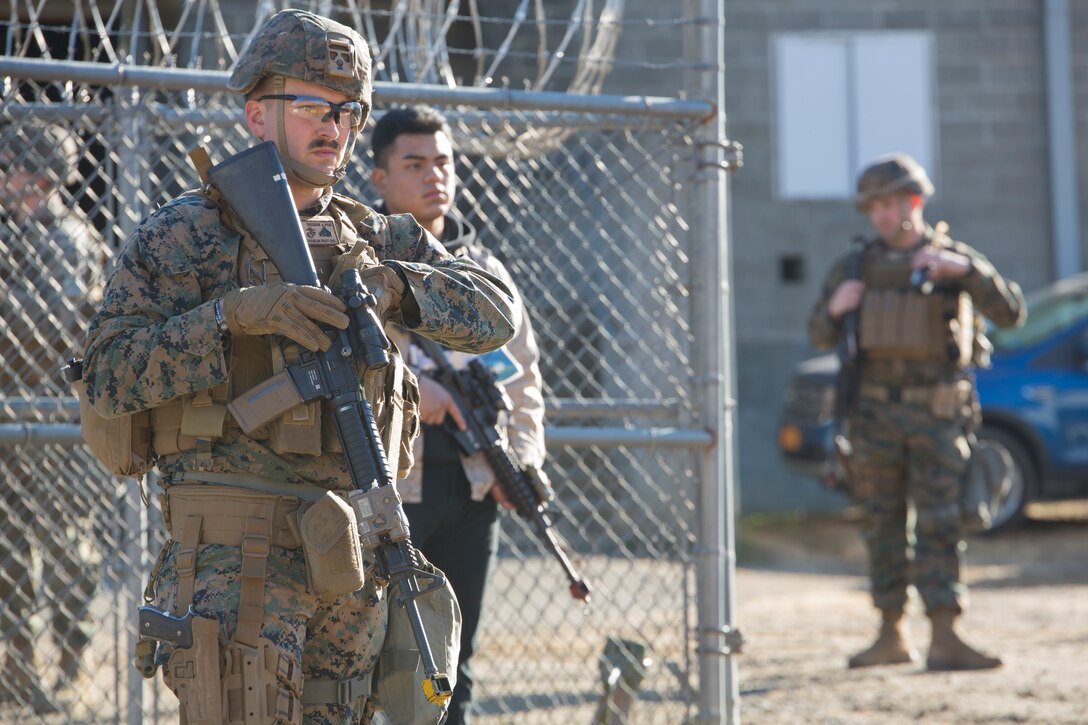 U.S. Marine Corps Cpl. Ian Remers, a military police officer with Charlie FAST Company, 5th Platoon, Marine Corps Security Force Regiment stands guard during a Mission Readiness Exercise (MRX) Jan 12, 2021, on Fort A. P. Hill in Port Royal, Virginia. Fleet Antiterrorism Security Team (FAST) platoons execute MRX exercises prior to deployment to evaluate the platoons’ proficiency in core mission essential tasks. (U.S. Marine Corps Photo by Sgt. Desmond Martin/Released)