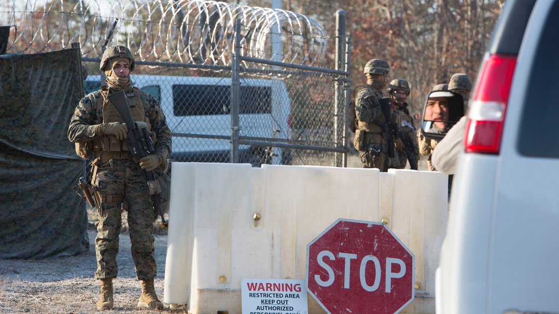 U.S. Marine Corps Cpl. Cameron Northern, a military police officer with Charlie FAST Company, 5th Platoon, Marine Corps Security Forces, U.S. Marine Corps Forces Command, Fleet Marine Force Atlantic, issues commands to a contractor role playing as a plumber during a Mission Readiness Exercise (MRX) Jan 13, 2021, on Fort A. P. Hill in Port Royal, Virginia. Fleet Antiterrorism Security Team (FAST) platoons execute MRX exercises prior to deployment to evaluate the platoons’ proficiency in core mission essential tasks. (U.S. Marine Corps Photo by Sgt. Desmond Martin/Released)
