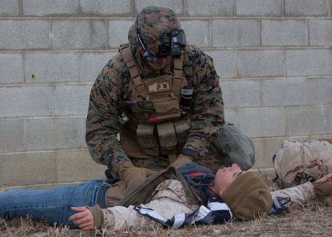U.S. Navy Petty Officer 3rd Class Robert Mears, a corpsman with Charlie FAST Company, 5th Platoon, Marine Corps Security Force Regiment applies first aid to a notional gunshot wound during a Mission Readiness Exercise (MRX) Jan 13, 2021, on Fort A. P. Hill in Port Royal, Virginia. Fleet Antiterrorism Security Team (FAST) platoons execute MRX exercises prior to deployment to evaluate the platoons’ proficiency in core mission essential tasks. (U.S. Marine Corps Photo by Sgt. Desmond Martin/Released)