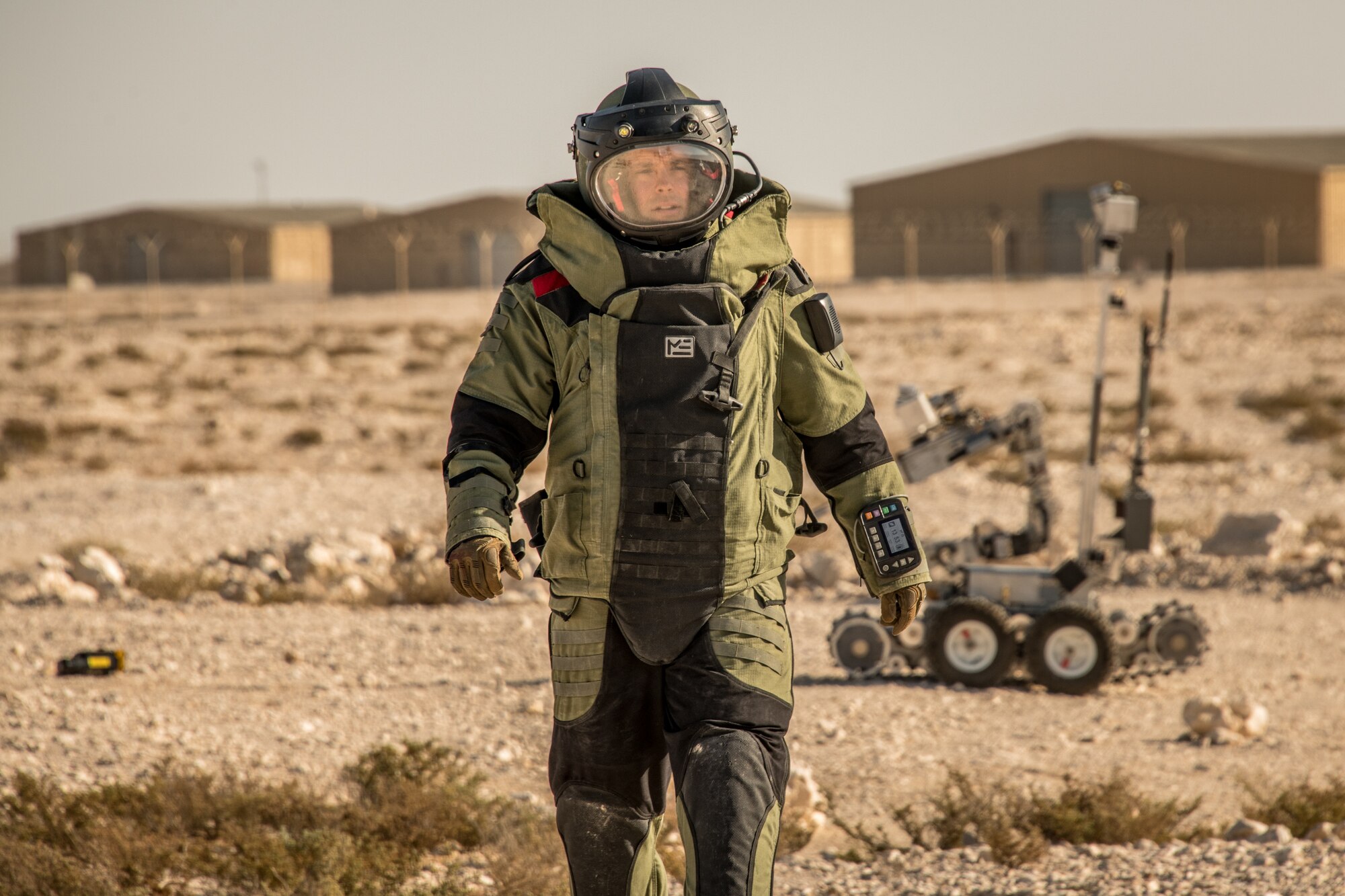 A man walks in an explosive ordnance disposal protection suit