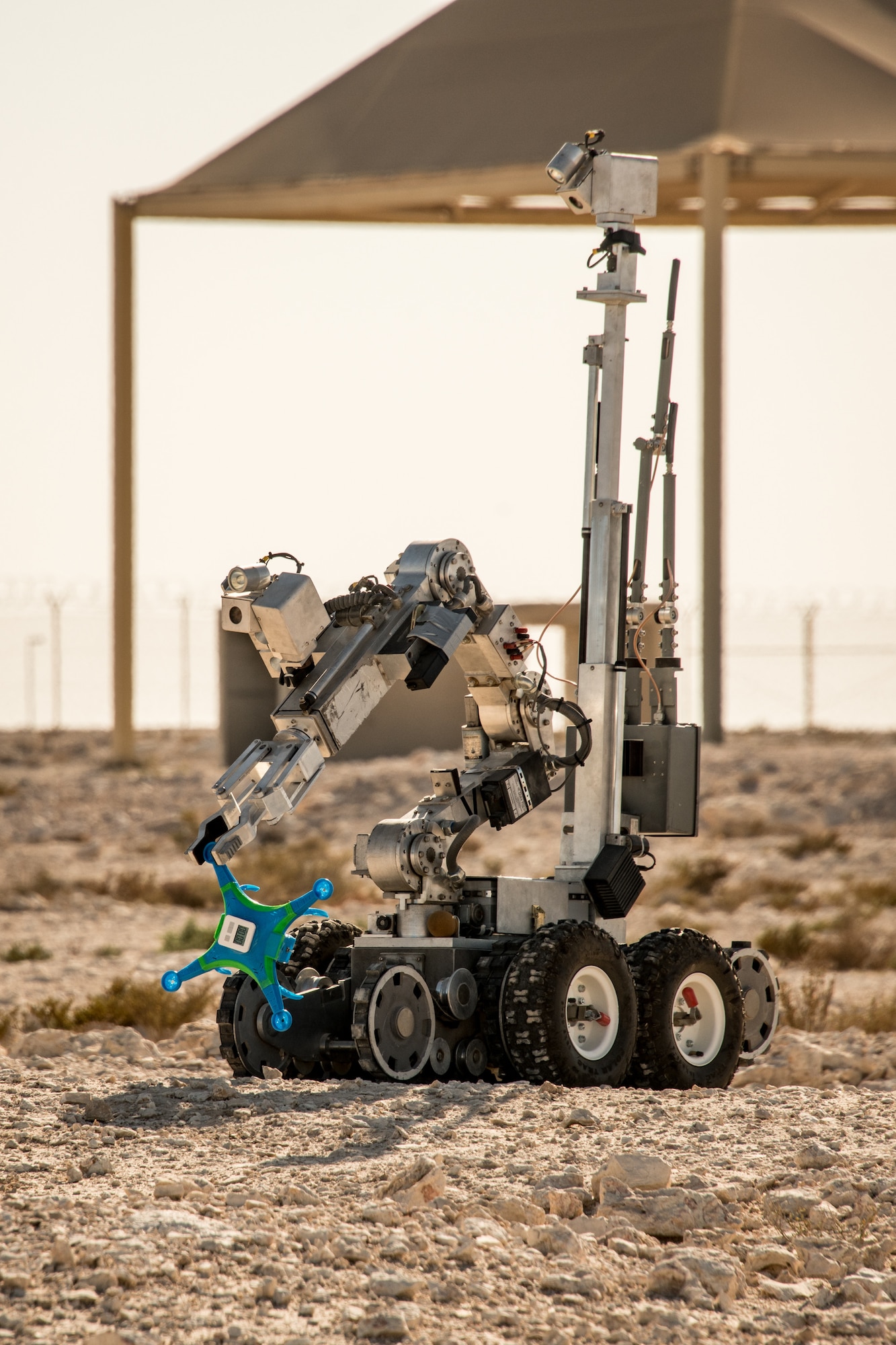 a robot picks up an improvised explosive device