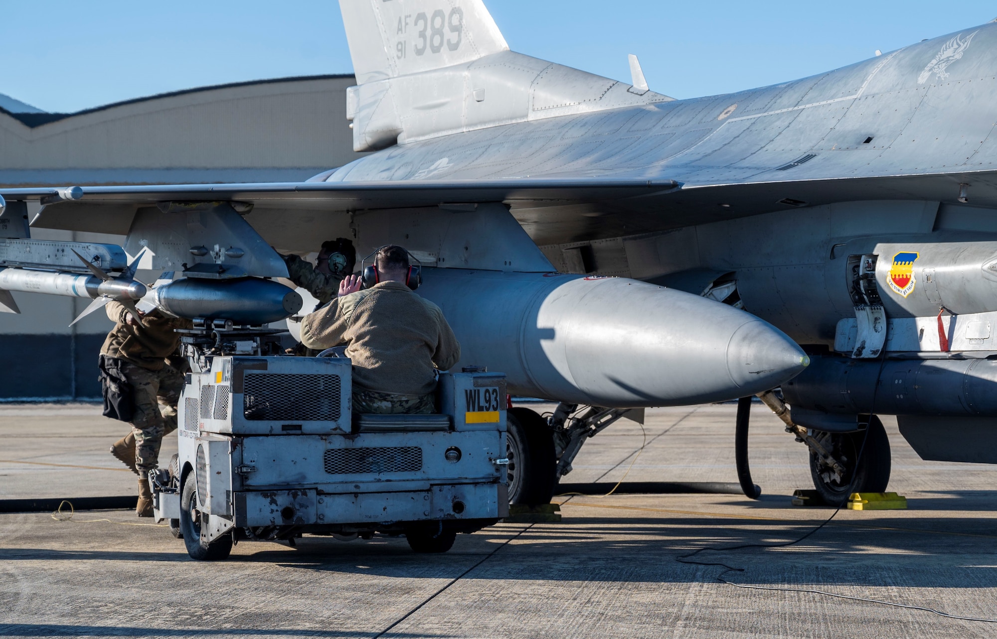 Photo of Airmen loading munition