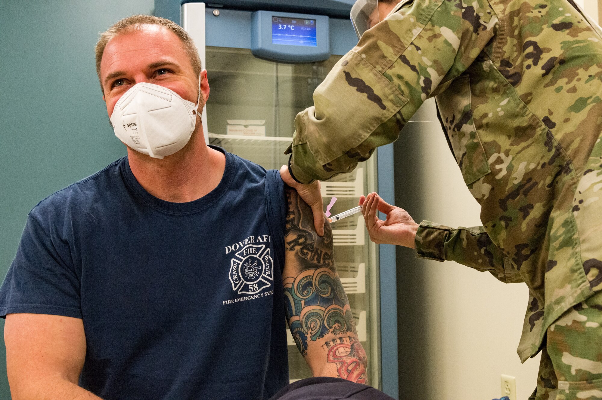 Jonathan Nordstrom, 436th Civil Engineer Squadron fire department firefighter and driver, is administered the COVID-19 vaccine by Senior Airman Bianca Robichaud, 436th Health Care Operations Squadron acting family health noncommissioned officer in charge, Jan. 15, 2021, at Dover Air Force Base, Delaware. Nordstrom was among the first Team Dover frontline workers who voluntarily received the vaccine in concurrence with Department of Defense guidance. The vaccine was granted emergency use authorization by the U.S. Food and Drug Administration for use in prevention of COVID-19. (U.S. Air Force photo by Roland Balik)