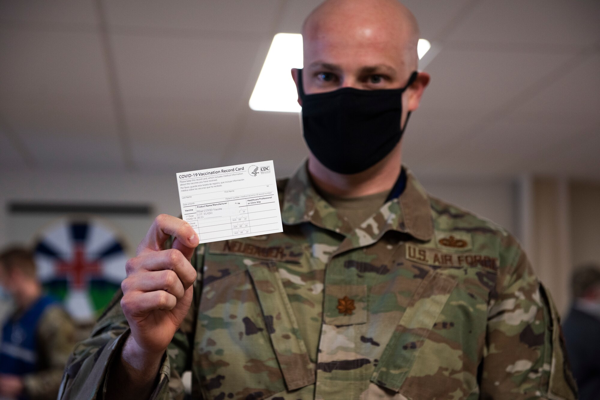 U.S. Air Force Maj. Andrew Neubauer, 366th Security Forces Squadron commander, holds up his COVID-19 vaccination card, at Mountain Home Air Force Base, Idaho, Jan. 19, 2021. Neubauer will receive his second dose of the vaccine in three weeks. (U.S. Air Force photo by Airman 1st Class Natalie Rubenak)